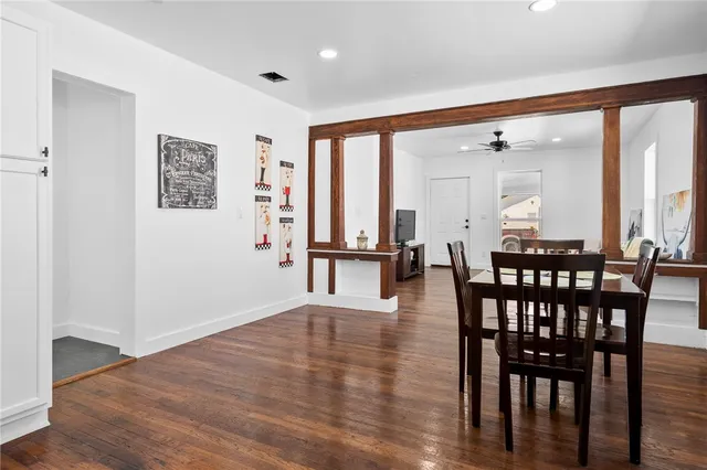 a view of a a dining room with furniture window and wooden floor