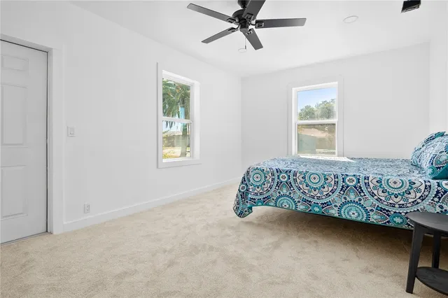 a bed sitting in a bedroom next to a window