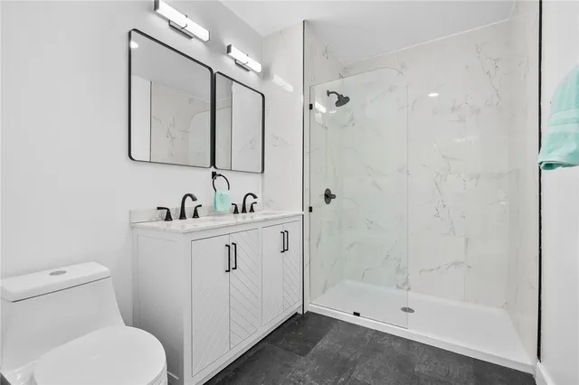 a bathroom with a toilet sink and shower