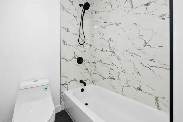 a bathroom with a bathtub and toilet