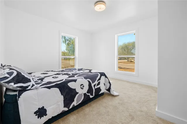 a bed sitting in a bedroom next to a window