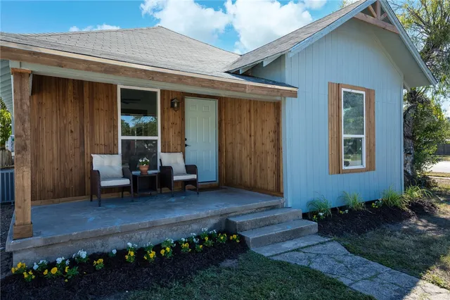 a front view of a house with a garden