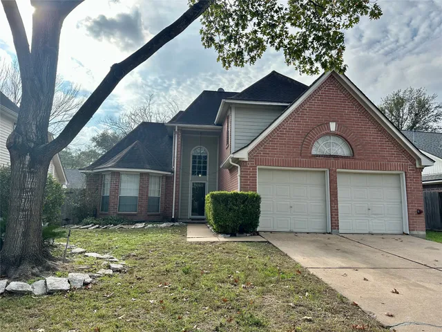 a view of a house with a yard and garage