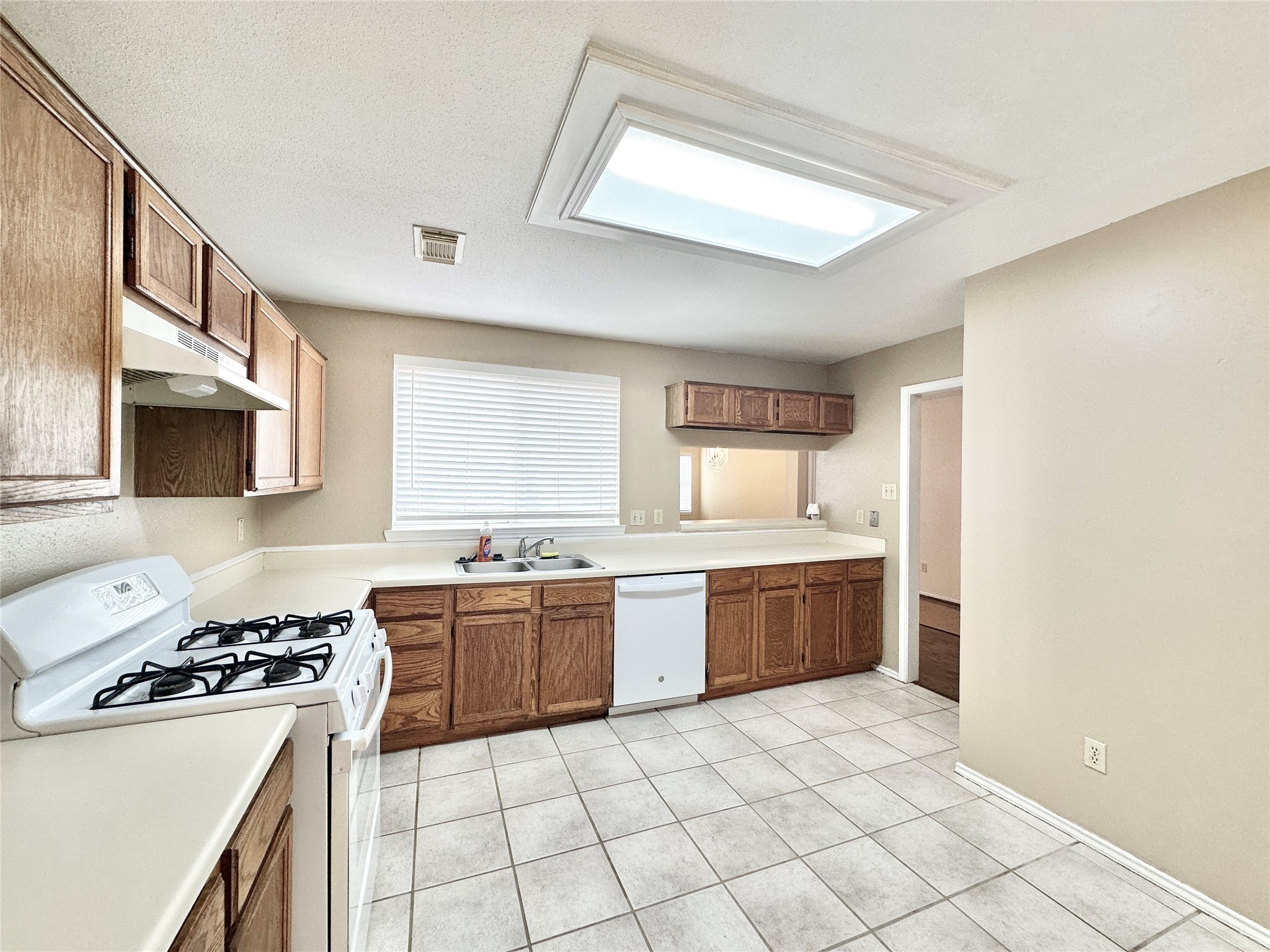 16827 Ashbridge Court Spring, TX 77379 - Photo 6 of 22 a kitchen with a stove a sink and a refrigerator