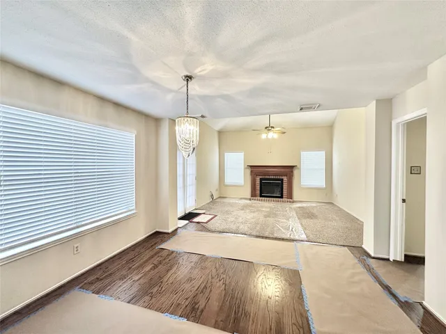 a view of an empty room and a fireplace