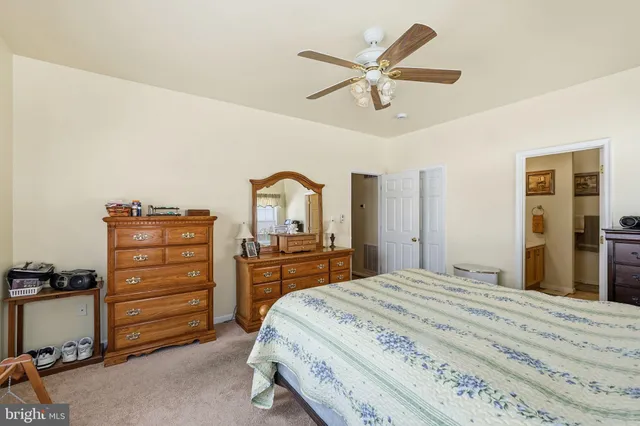 a bedroom with a bed and a dresser