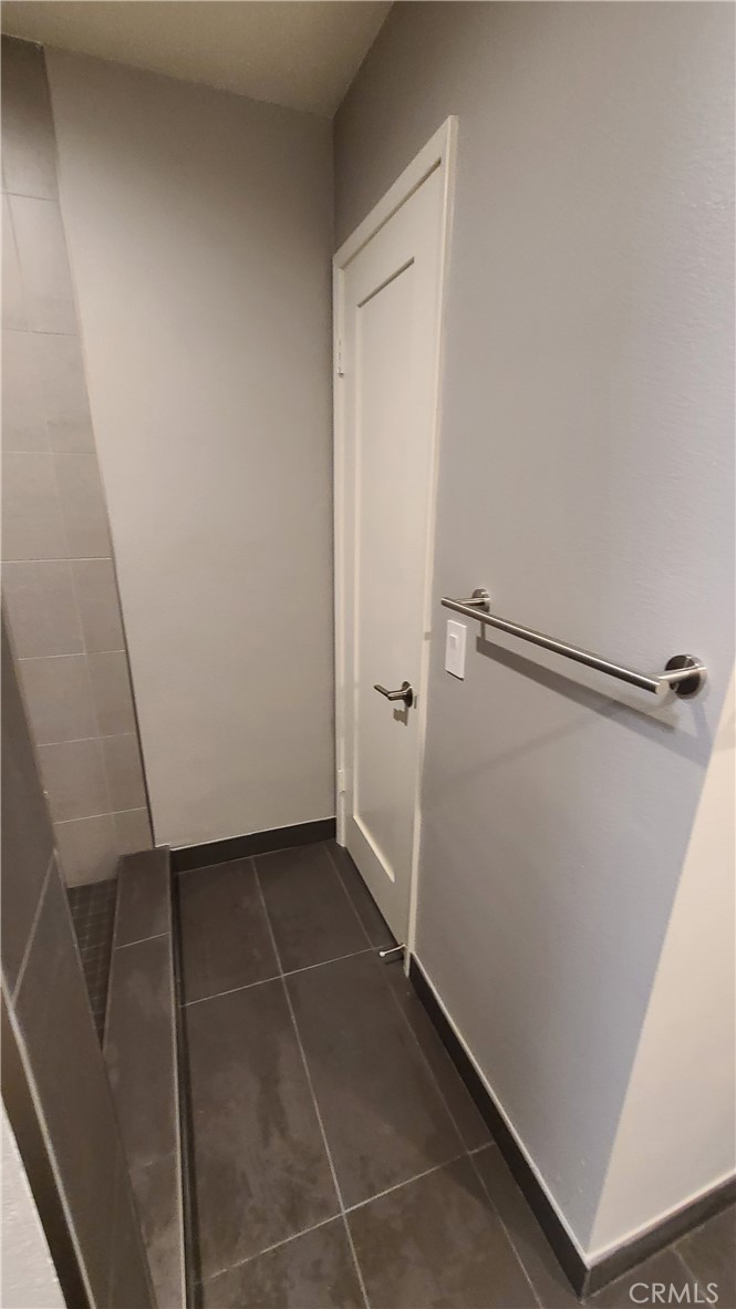 215 Lower Cliff Drive, Unit B Laguna Beach, CA 92651 - Photo 11 of 17 a bathroom with a shower and a tiled wall