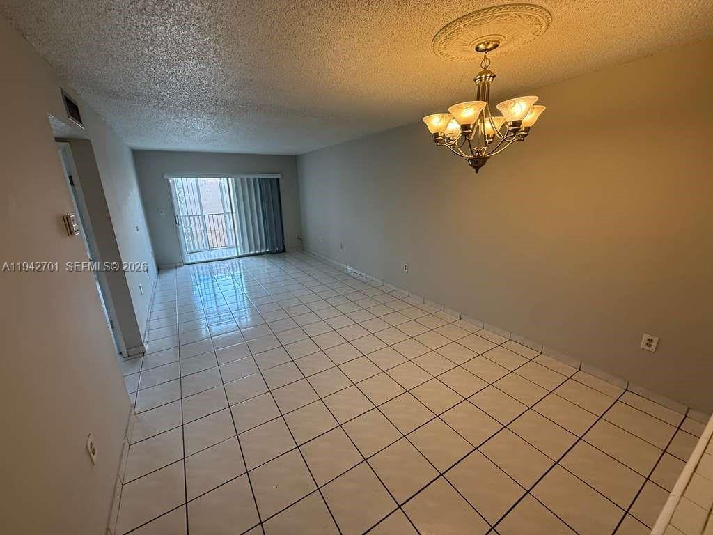305 West 68th Street, Unit 519 Hialeah, FL 33014 - Photo 3 of 11 a view of a livingroom with a chandelier