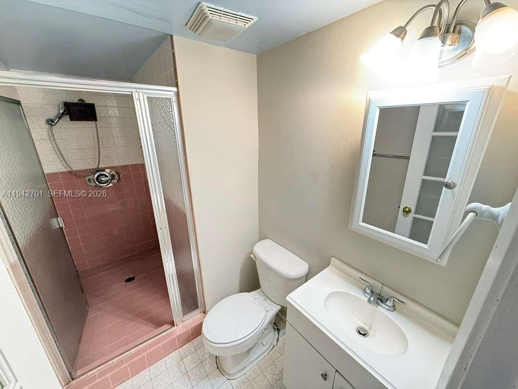 305 West 68th Street, Unit 519 Hialeah, FL 33014 - Photo 5 of 11 a bathroom with a sink and mirror with toilet