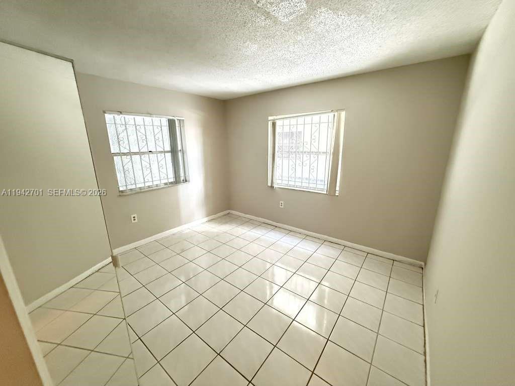 305 West 68th Street, Unit 519 Hialeah, FL 33014 - Photo 6 of 11 a view of an empty room and window