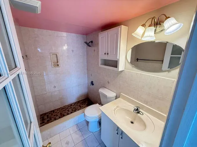 a bathroom with a sink toilet and mirror