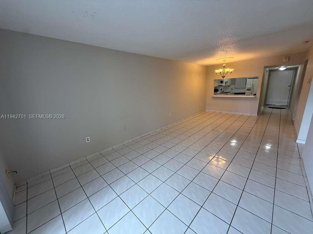 305 West 68th Street, Unit 519 Hialeah, FL 33014 - Photo 10 of 11 a view of a livingroom with furniture and an entryway