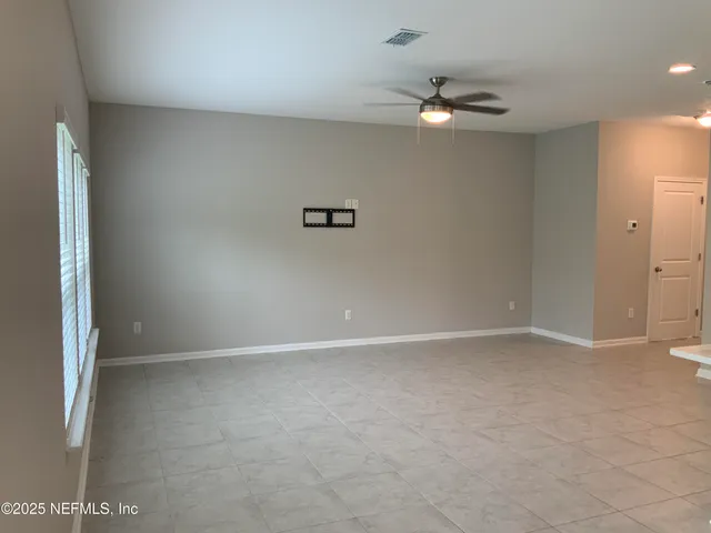 an empty room with windows and closet