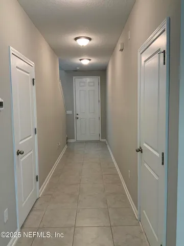 a kitchen with a sink and white cabinets