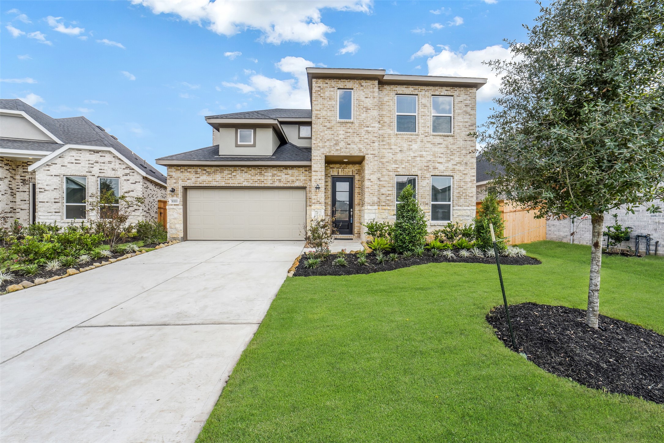 a front view of house with a garden
