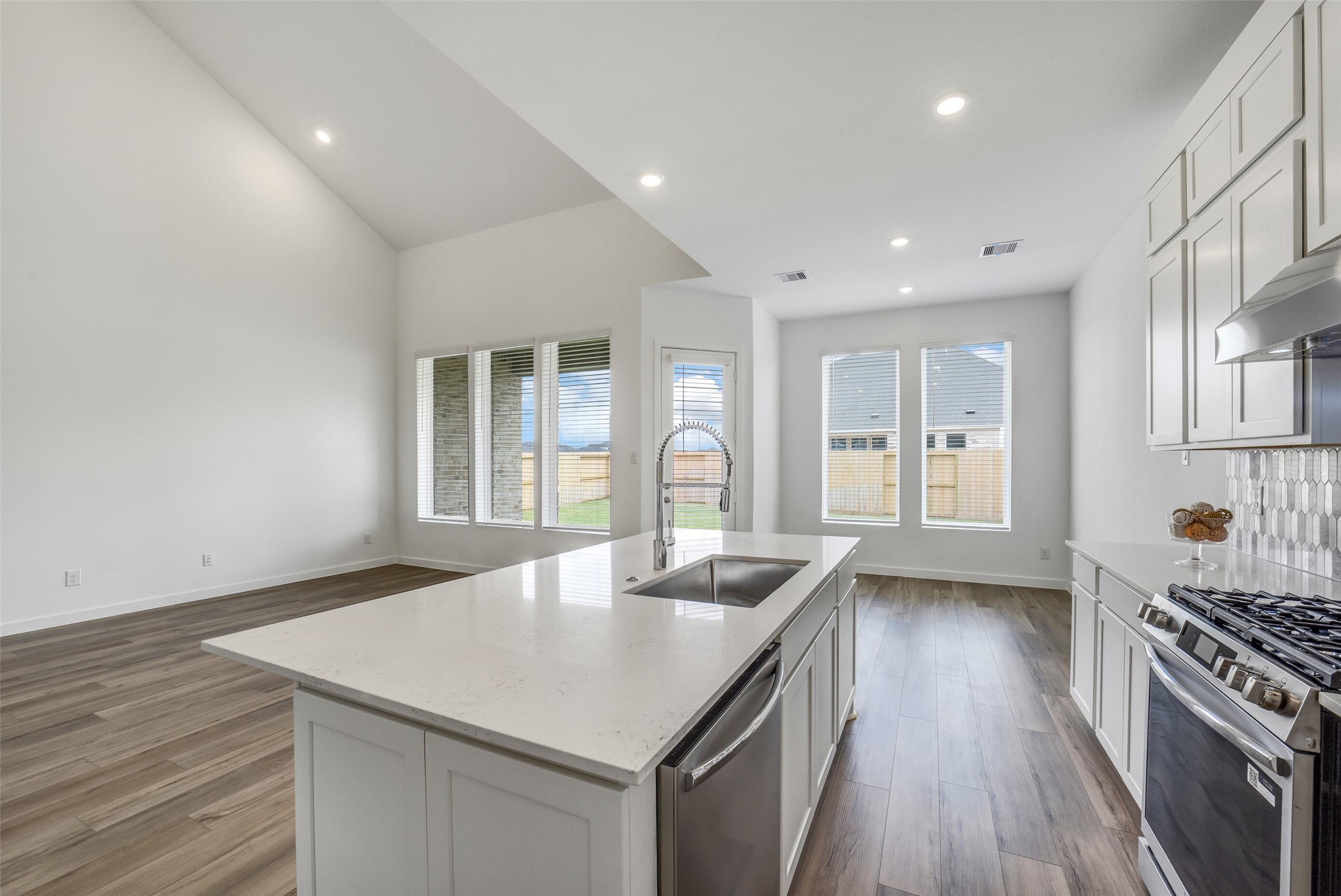31111 Marlow Mnr Court Fulshear, TX 77441 - Photo 11 of 34 a kitchen with a stove a sink and a refrigerator