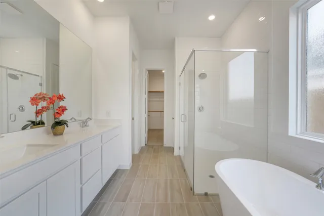 a bathroom with a sink mirror and shower