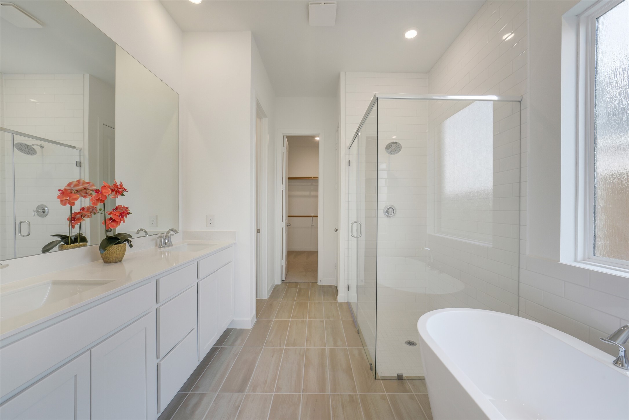 31111 Marlow Mnr Court Fulshear, TX 77441 - Photo 16 of 34 a bathroom with a sink mirror and shower