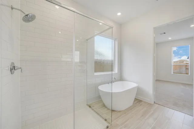 a bathroom with a bathtub and shower