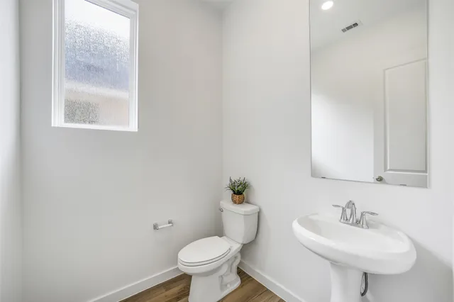a bathroom with a sink toilet and a mirror