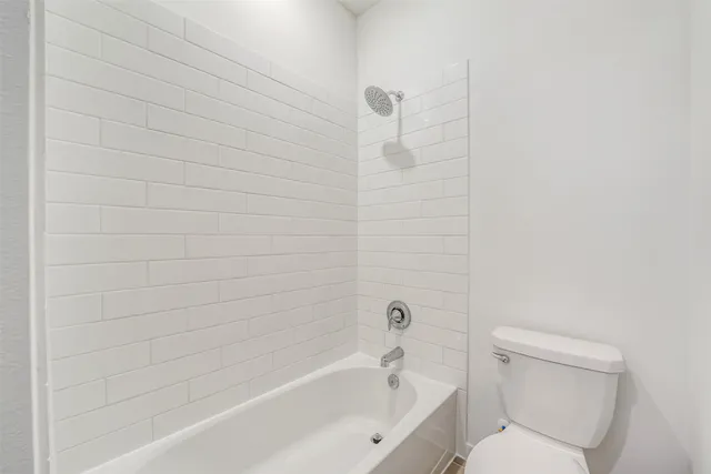 a bathroom with a toilet and bathtub