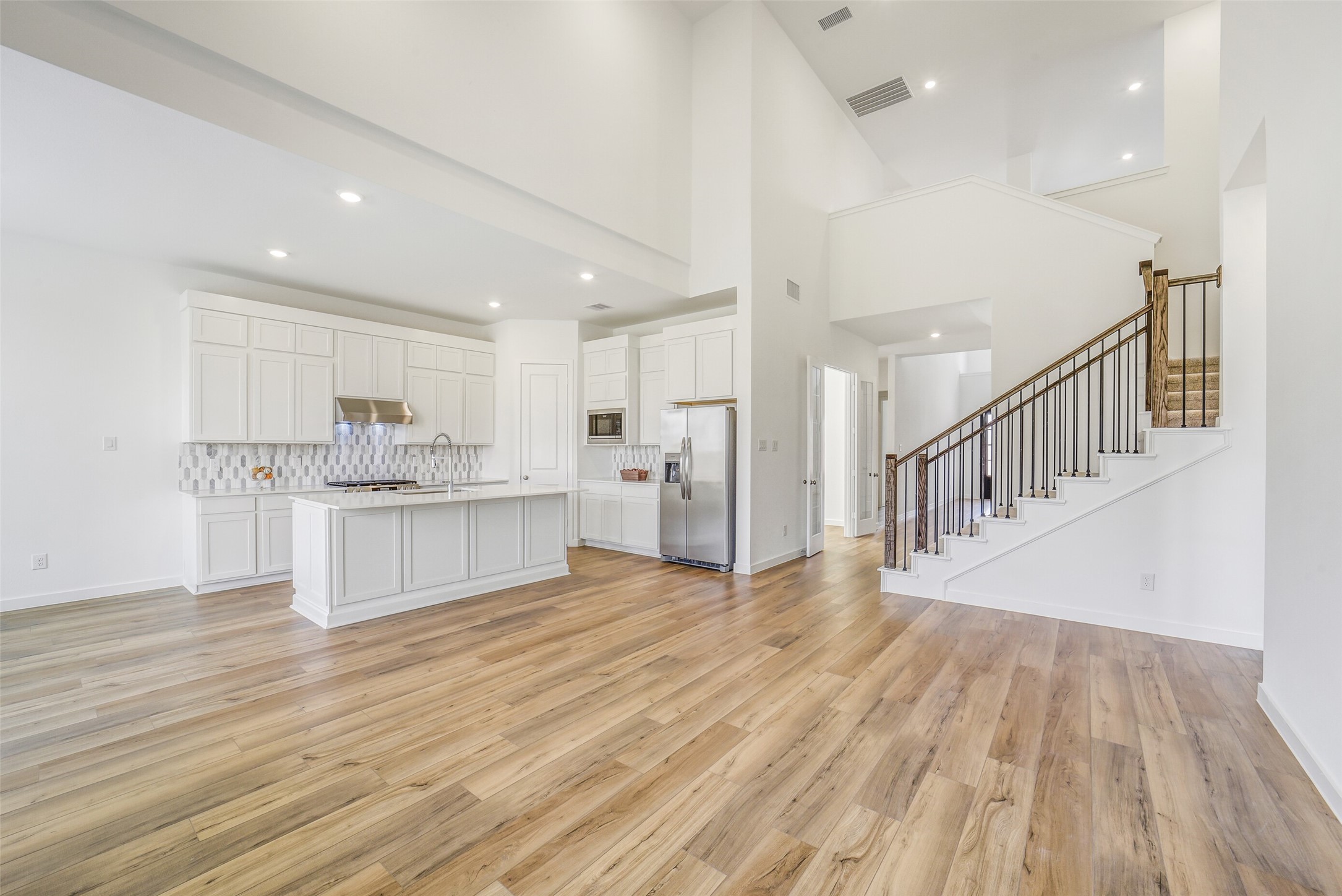 31111 Marlow Mnr Court Fulshear, TX 77441 - Photo 5 of 34 a view of a kitchen with wooden floor