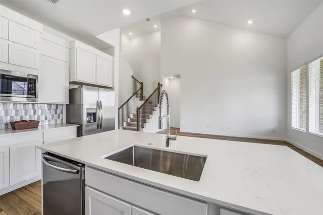 a kitchen with a sink and a refrigerator