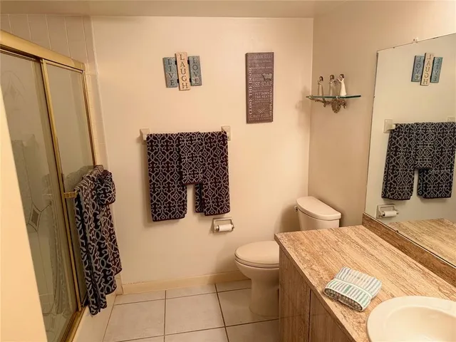 a bathroom with a toilet sink and shower