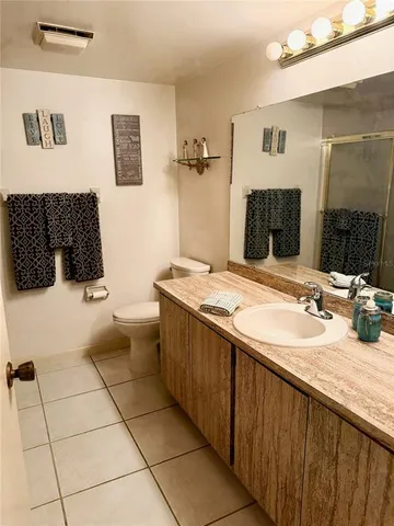 a bathroom with a granite countertop sink a mirror and a bathtub