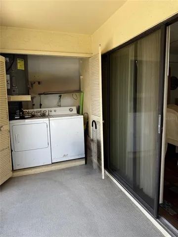 a utility room with a refrigerator and a sink