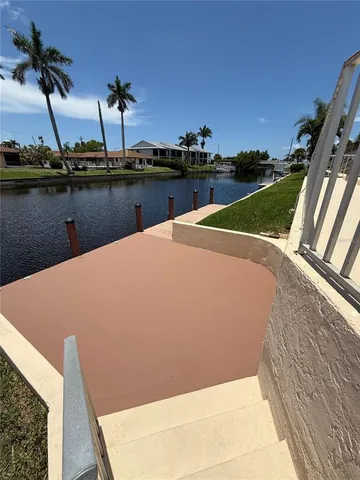 a view of house with swimming pool and furniture