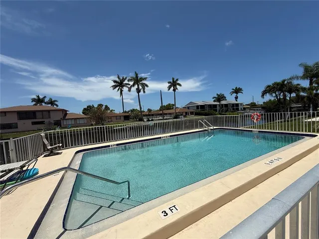 a view of a lake with houses in the back