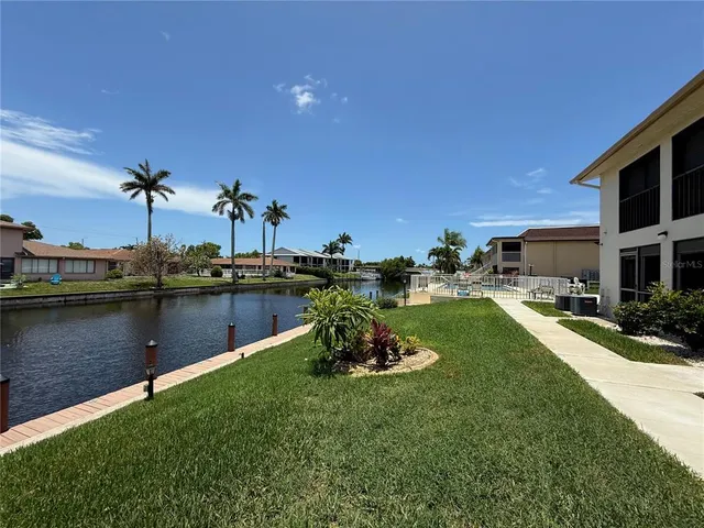 a swimming pool with a yard in the back