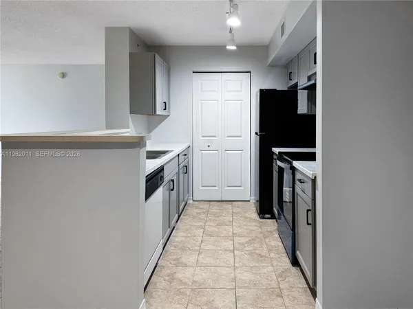 a kitchen with stainless steel appliances a refrigerator and a stove