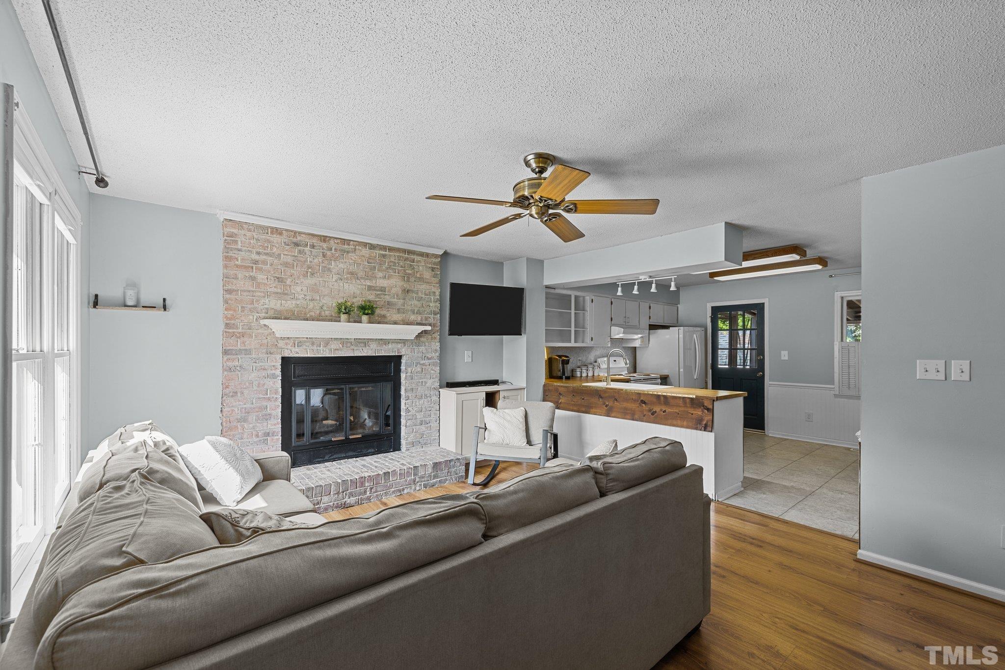 208 Longneedle Court Raleigh, NC 27603 - Photo 2 of 24 a living room with furniture and a fireplace