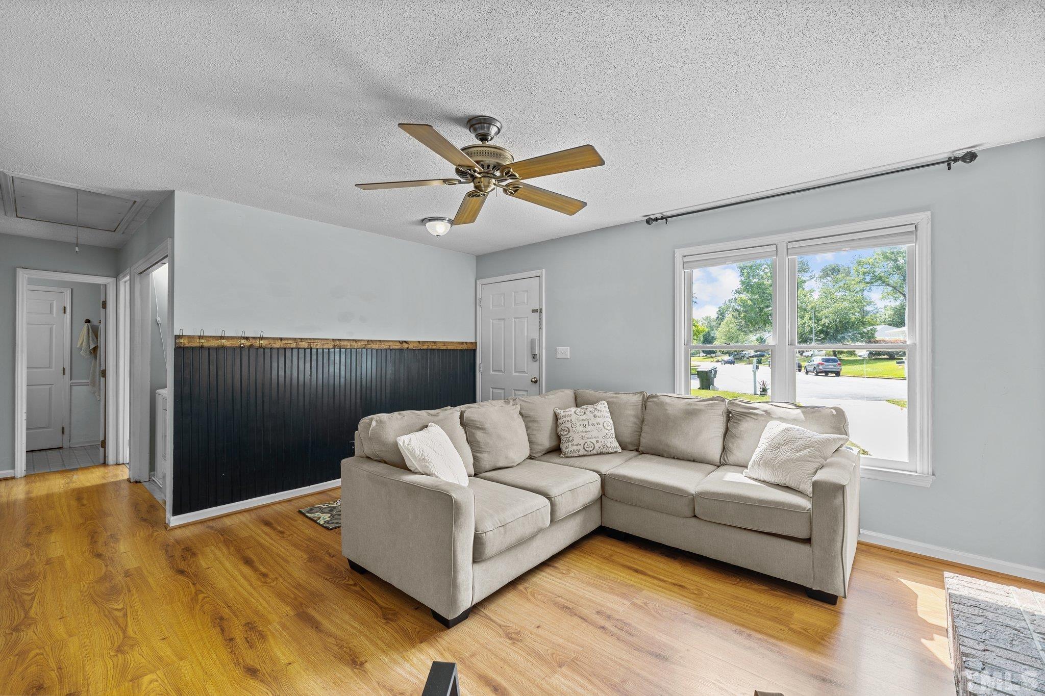 208 Longneedle Court Raleigh, NC 27603 - Photo 5 of 24 a living room with furniture and a large window