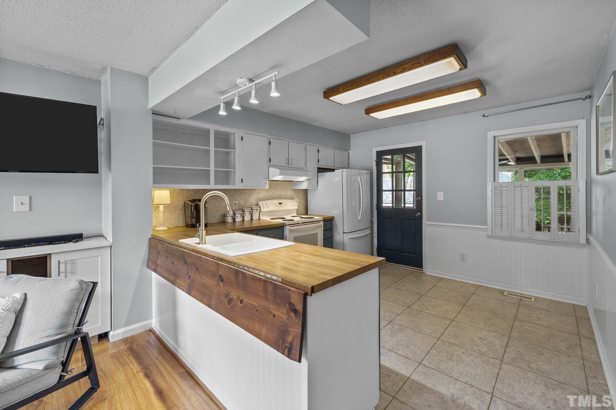 208 Longneedle Court Raleigh, NC 27603 - Photo 6 of 24 a bedroom with a bed and wooden floor