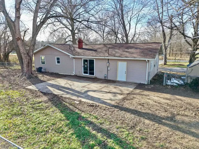 a view of a house with a yard covered in snow