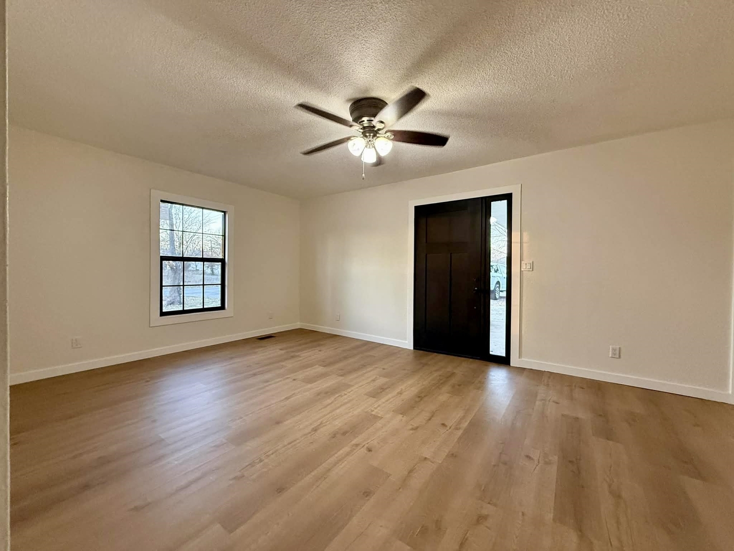 208 North Brown Street Benton, IL 62812 - Photo 17 of 31 a view of an empty room with window and wooden floor