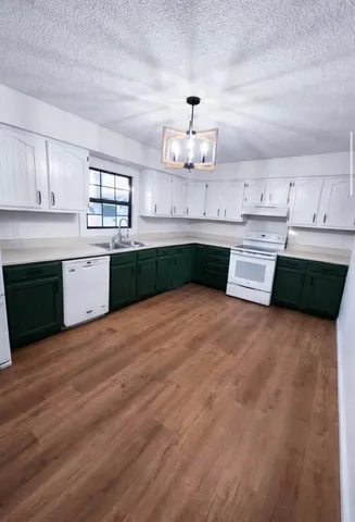 a kitchen with stainless steel appliances granite countertop a sink and cabinets