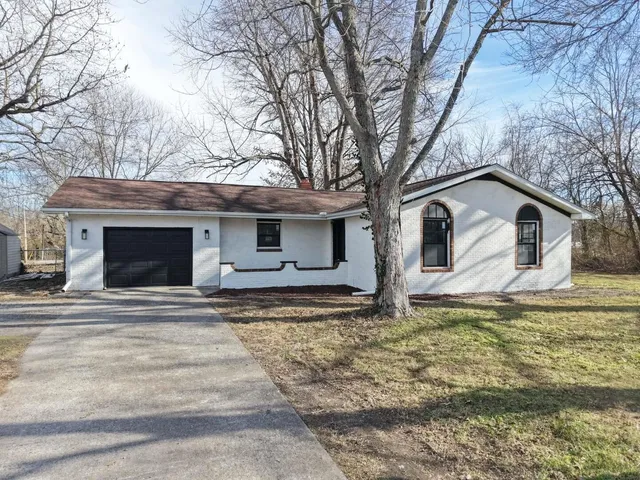 a view of a house with a large tree