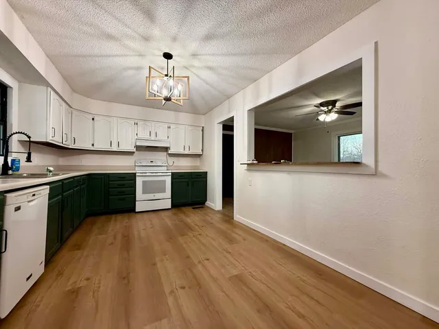 a kitchen with granite countertop stainless steel appliances and wooden cabinets