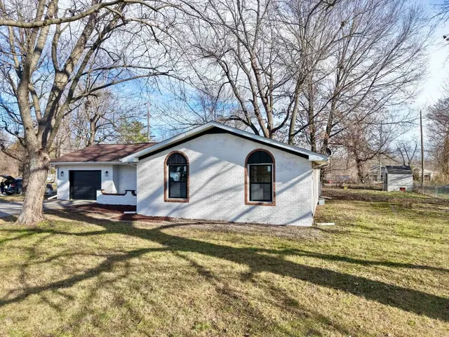 a view of a yard with a house in the background