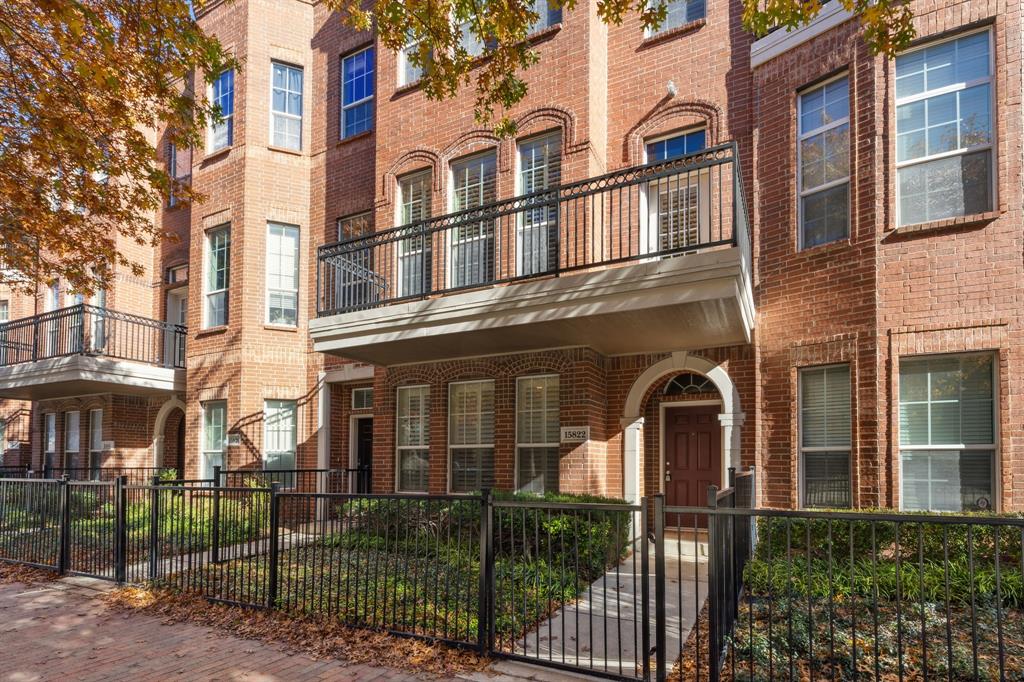 15822 Quorum Drive, Unit 104 Addison, TX 75001 - Photo 1 of 1 front view of a brick house with a large windows