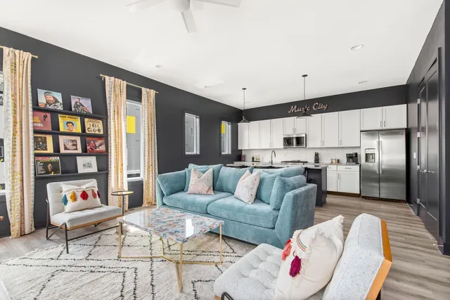a living room with furniture and kitchen view