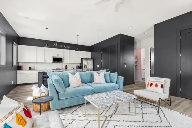 a kitchen with stainless steel appliances granite countertop a sink a stove a refrigerator and cabinets