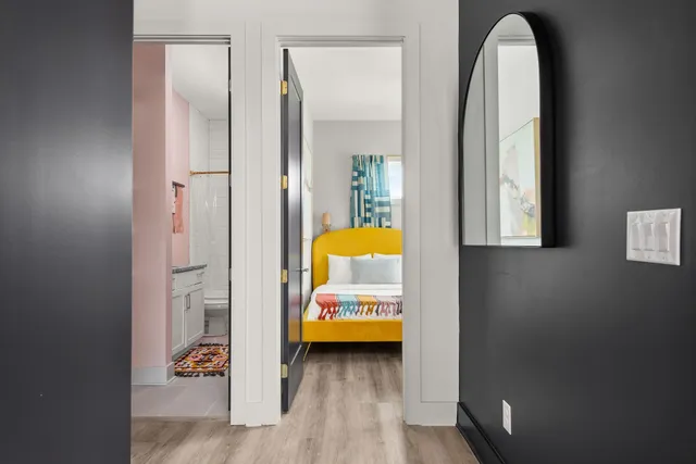 a bedroom with two beds and a large window