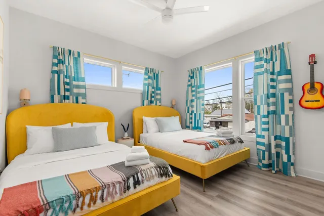 a living room with white cabinets and wooden floor
