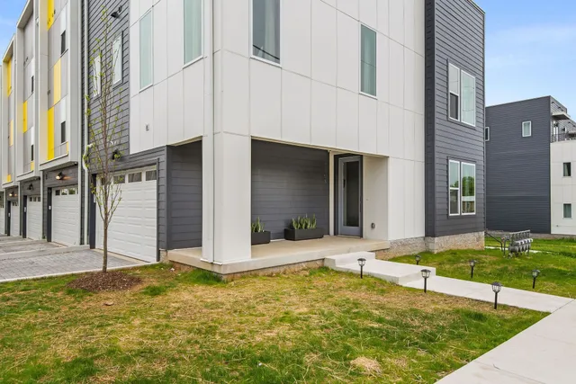 a roof deck with table and chairs