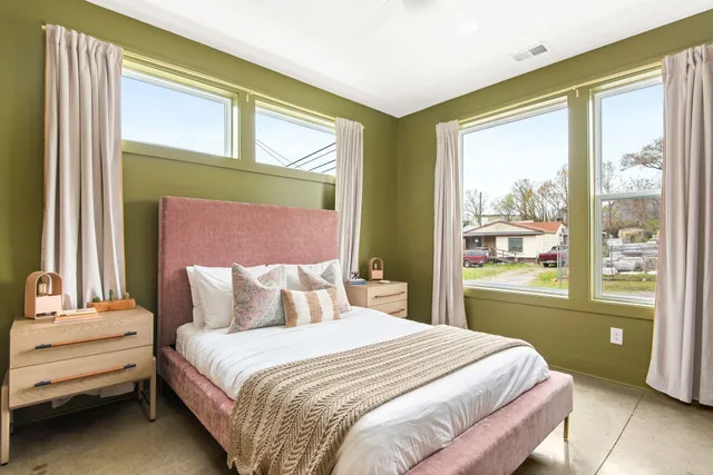 a bedroom with a bed and a flat screen tv